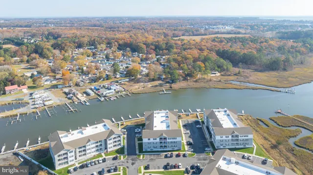 an aerial view of a city with lots of residential buildings and lake view