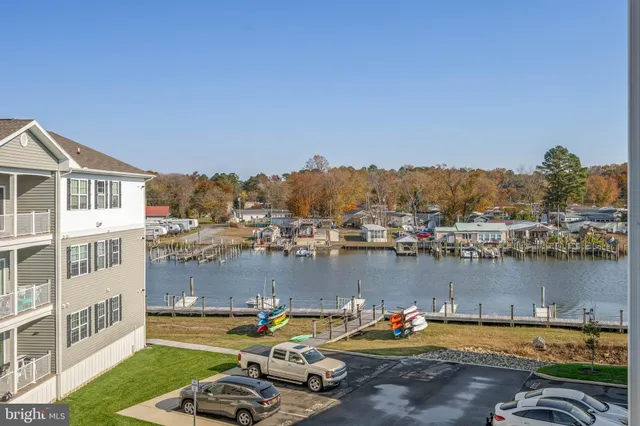 a view of a lake with house swimming pool and outdoor seating
