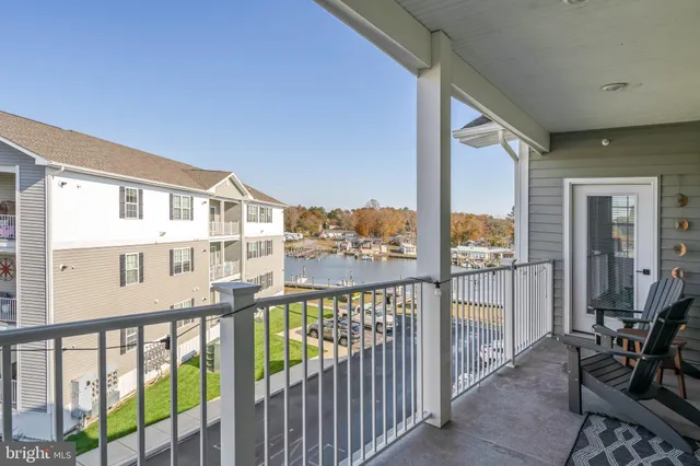a view of a balcony with floor to ceiling windows wooden floor and wooden fence