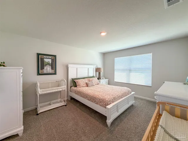 a bed room with a bed and a window