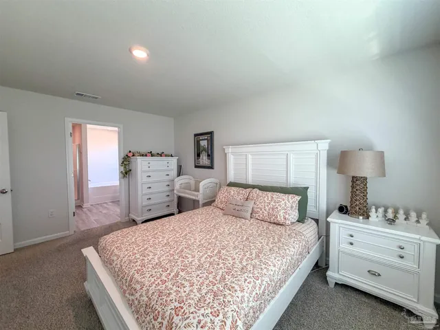 a bedroom with a bed and a lamp