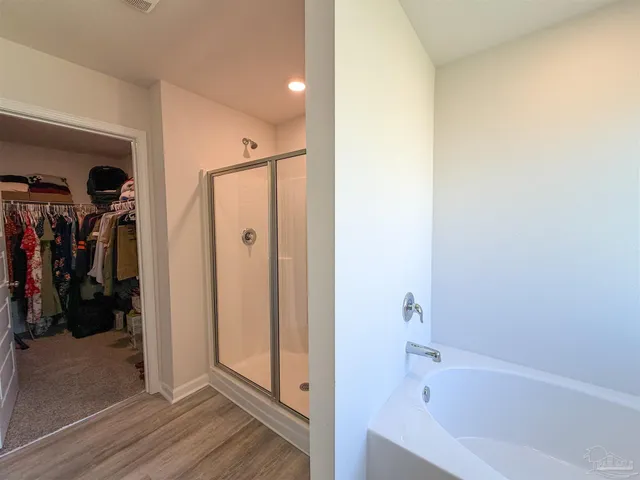 a bathroom with a bathtub and a shower