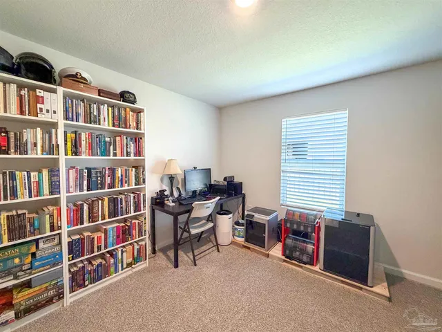 a reading room with furniture and a book shelf