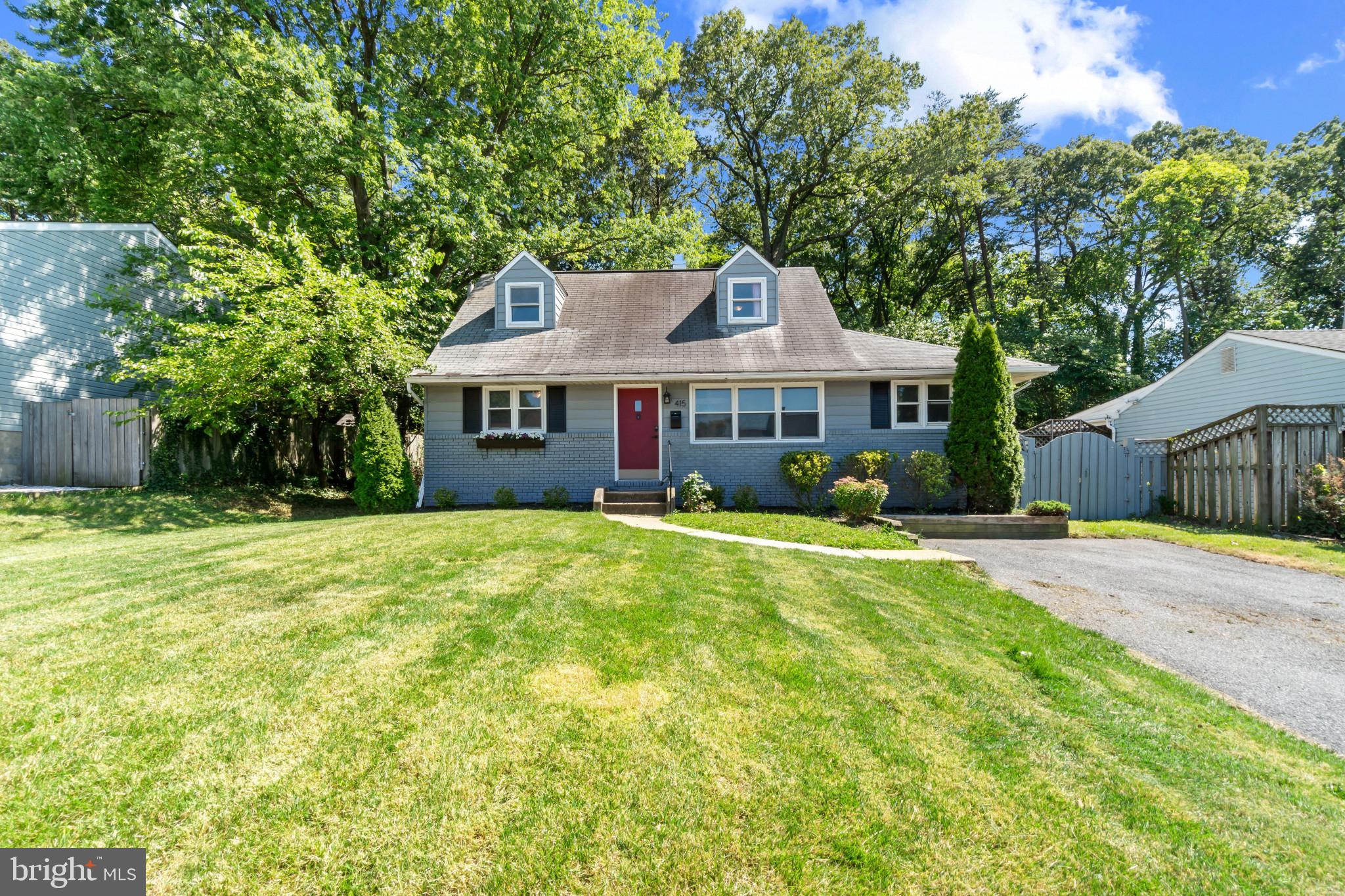 415 Baylor Road Glen Burnie, MD 21061 - Photo 3 of 29 a view of a house with a yard and a large tree