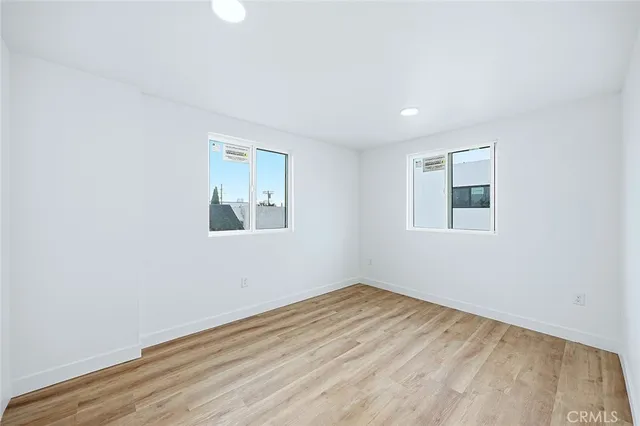 a view of a room with wooden floor