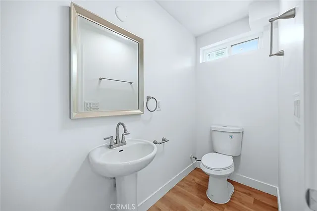 a view of a room with a wooden floor and white walls