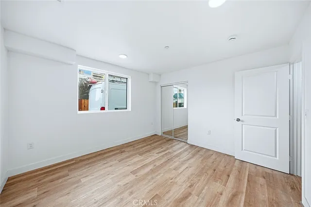 a kitchen with stainless steel appliances granite countertop a refrigerator a sink dishwasher a stove with wooden cabinets and floors