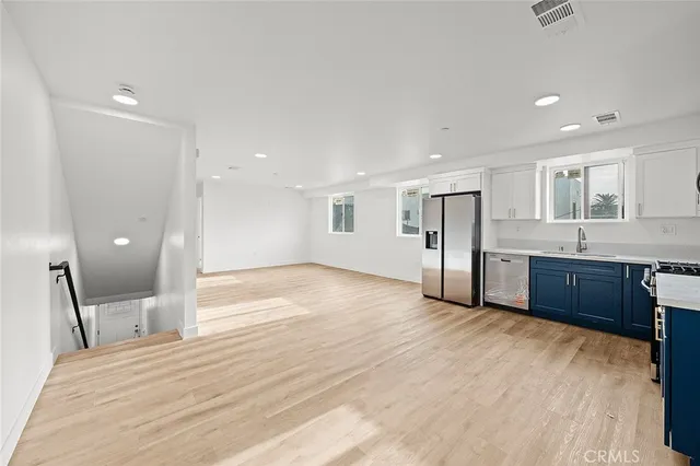 a view of a room with wooden floor and bathroom