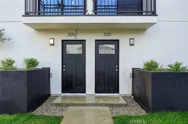 a kitchen with granite countertop a refrigerator stove and microwave
