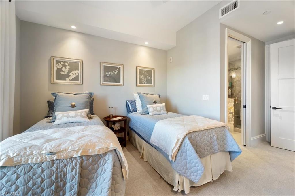 1035 3rd Avenue South, Unit 401 Naples, FL 34102 - Photo 15 of 43 a bedroom with two beds and painting on the wall