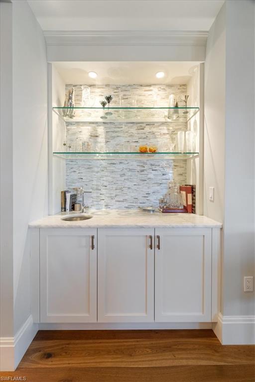 1035 3rd Avenue South, Unit 401 Naples, FL 34102 - Photo 26 of 43 a kitchen with granite countertop white cabinets and a sink
