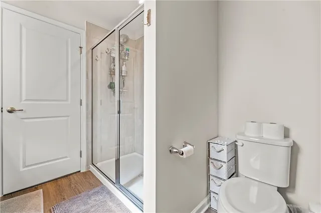 a bathroom with a toilet and a shower