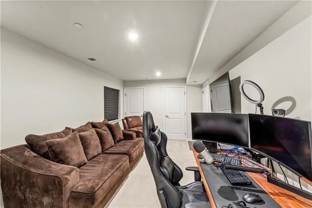 a bedroom with furniture and a flat screen tv