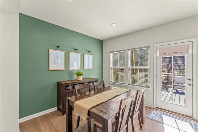 a view of a dining room with furniture window and wooden floor