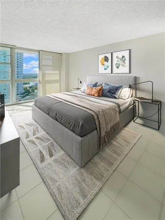 a spacious bedroom with a bed and glass window