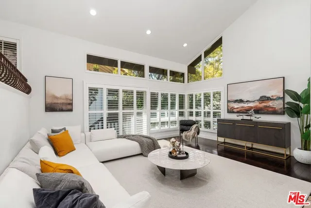 a bedroom with furniture and a large window