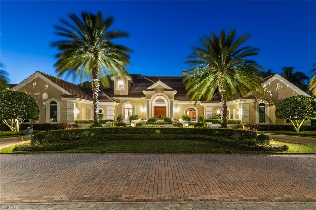 6963 Verde Way Naples, FL 34108 - Photo 1 of 31 a view of a house with a yard and palm trees