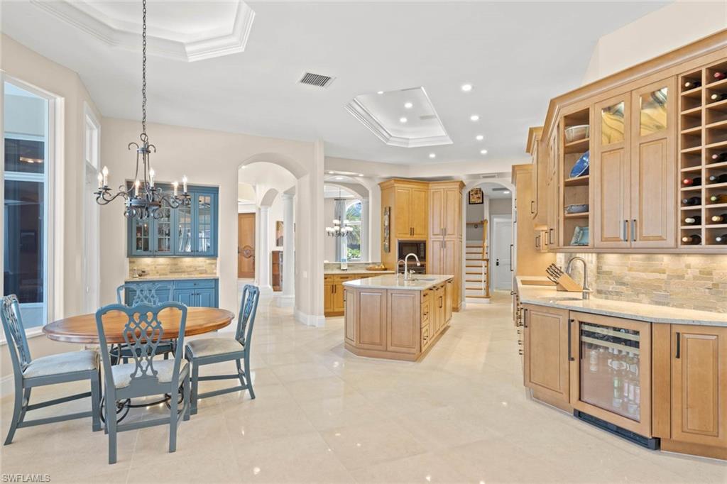 6963 Verde Way Naples, FL 34108 - Photo 13 of 31 a large kitchen with a table and chairs