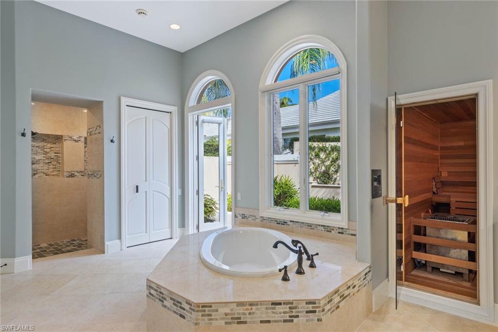 6963 Verde Way Naples, FL 34108 - Photo 18 of 31 a bathroom with a tub and a window