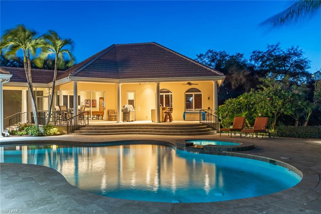 6963 Verde Way Naples, FL 34108 - Photo 23 of 31 a view of a house with pool and sitting area