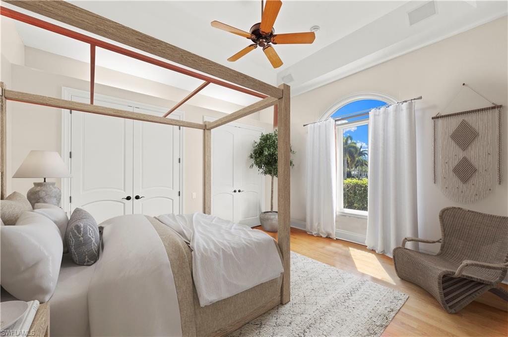 6963 Verde Way Naples, FL 34108 - Photo 24 of 31 a spacious bedroom with a bed a window and glass door