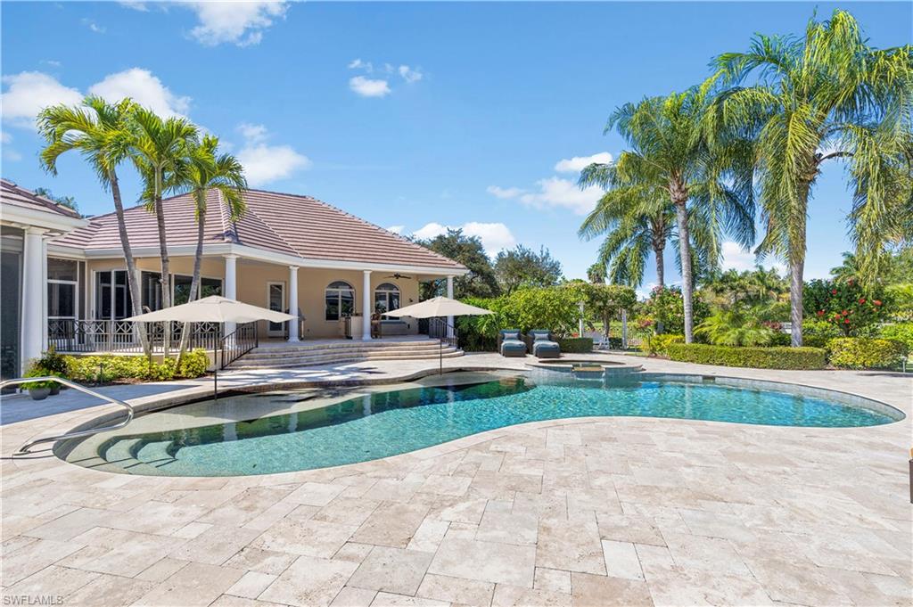 6963 Verde Way Naples, FL 34108 - Photo 28 of 31 a view of a house with swimming pool and sitting area
