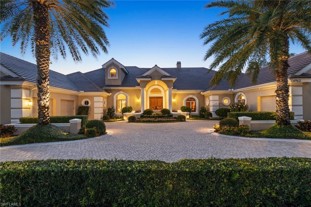 6963 Verde Way Naples, FL 34108 - Photo 29 of 31 a view of a house with a yard