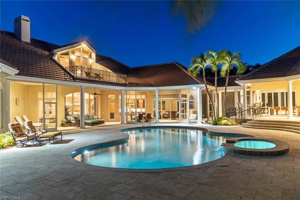 6963 Verde Way Naples, FL 34108 - Photo 30 of 31 a swimming pool with outdoor seating