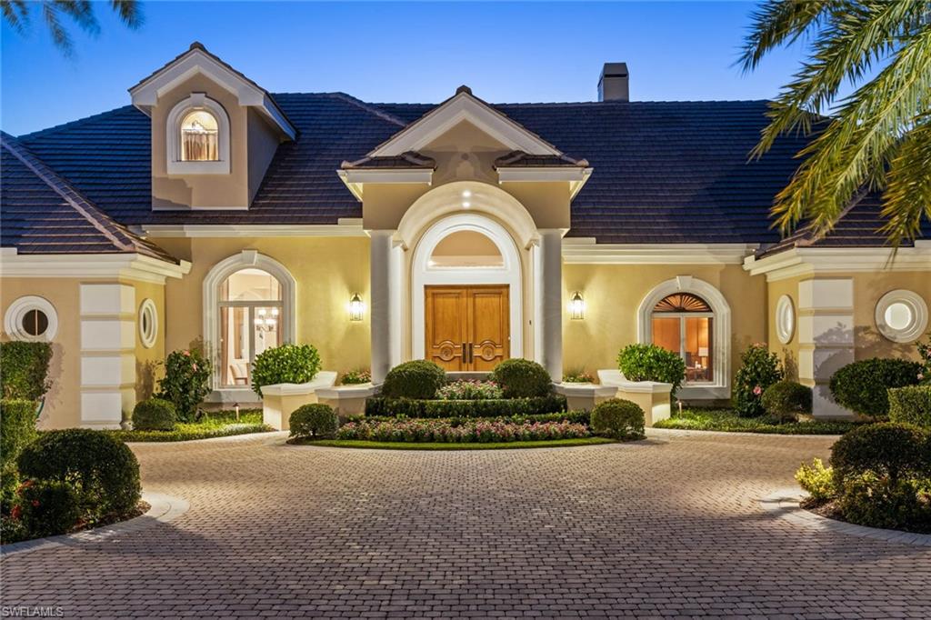 6963 Verde Way Naples, FL 34108 - Photo 3 of 31 a front view of a house with garden