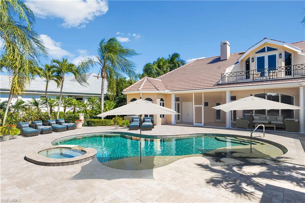 6963 Verde Way Naples, FL 34108 - Photo 4 of 31 a swimming pool with outdoor seating and yard