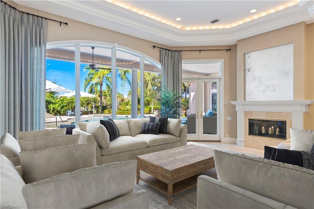6963 Verde Way Naples, FL 34108 - Photo 6 of 31 a living room with fireplace furniture and a large window