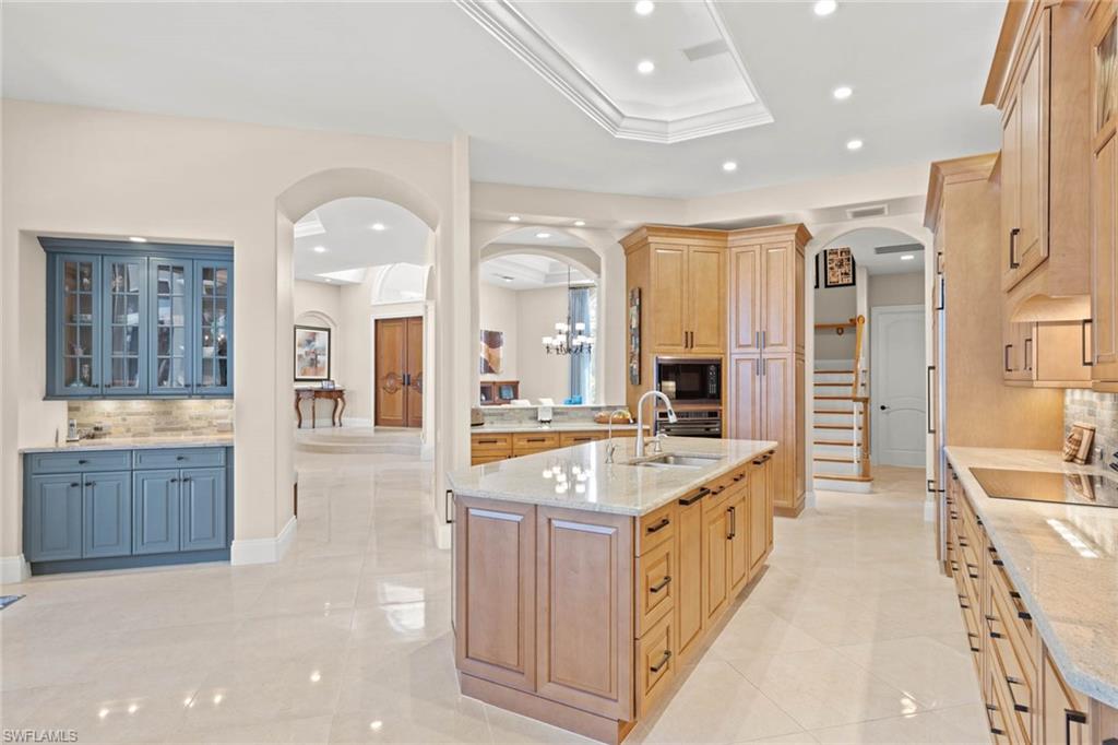 6963 Verde Way Naples, FL 34108 - Photo 9 of 31 a large bathroom with a granite countertop double vanity sink a mirror a bathtub and shower