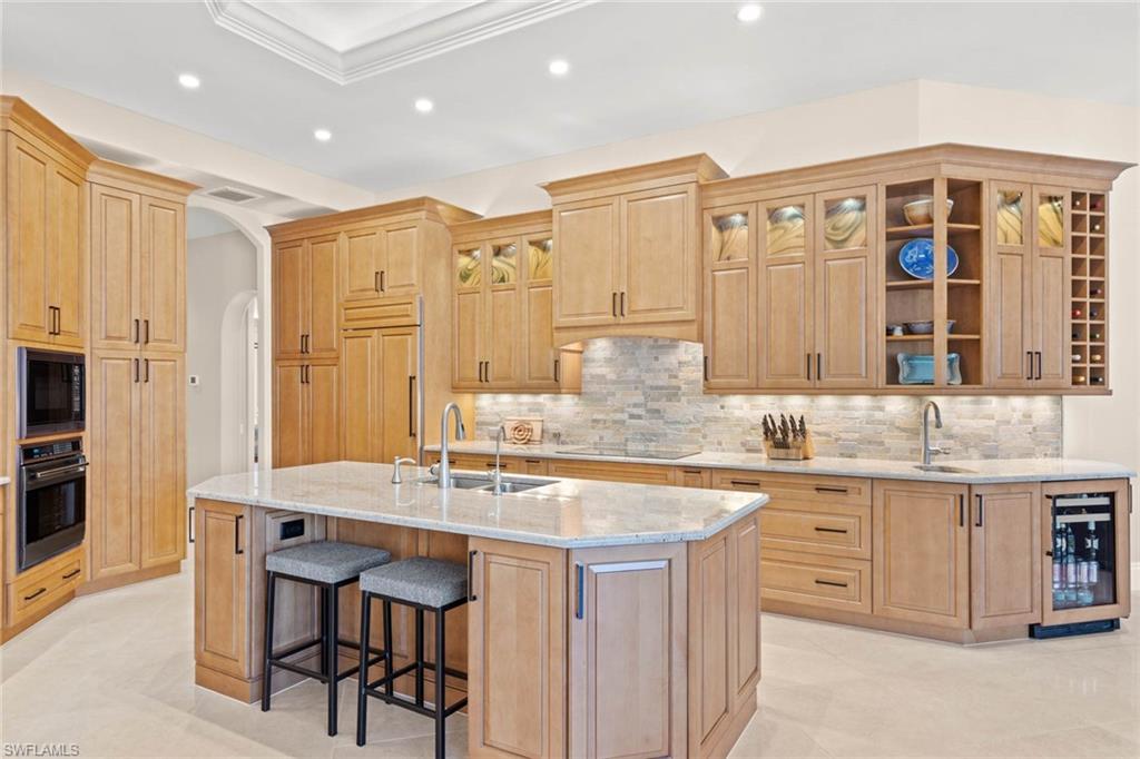 6963 Verde Way Naples, FL 34108 - Photo 10 of 31 a kitchen with stainless steel appliances granite countertop a sink and cabinets