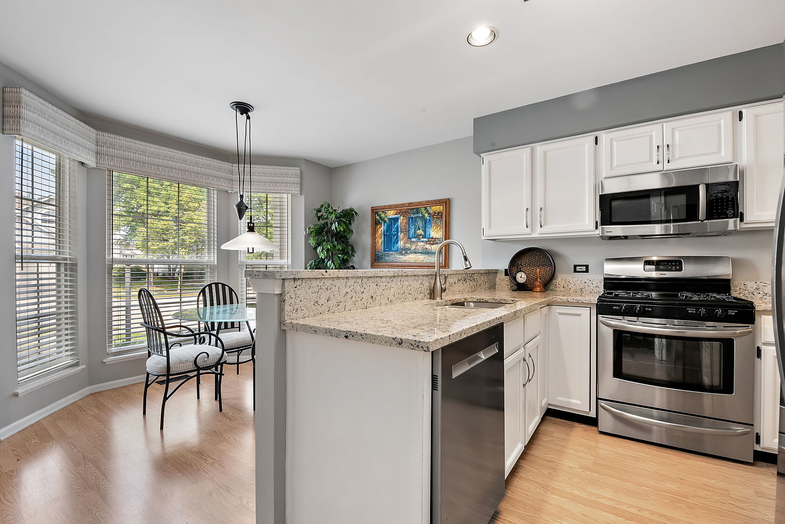 1061 Stillwater Road Elgin, IL 60120 - Photo 9 of 20 a kitchen with a stove a sink and a refrigerator