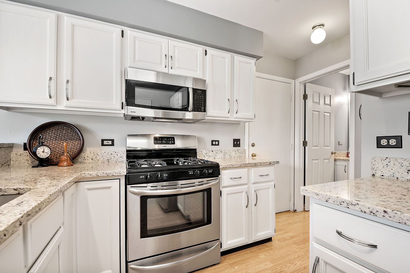 1061 Stillwater Road Elgin, IL 60120 - Photo 10 of 20 a kitchen with white cabinets and appliances