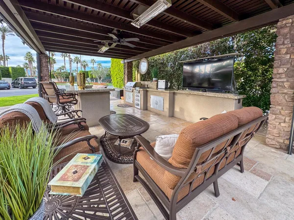 a outdoor living space with patio furniture and a fireplace