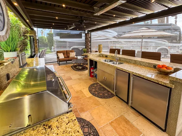 a view of patio with a couch and a fireplace