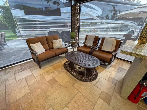 a view of patio with a table and chairs