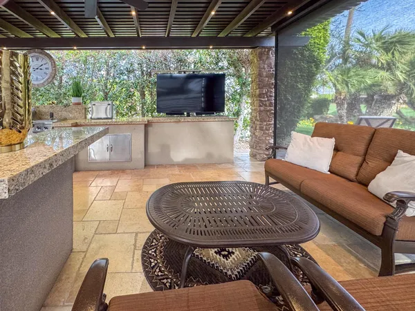 a building outdoor space with patio furniture and potted plants