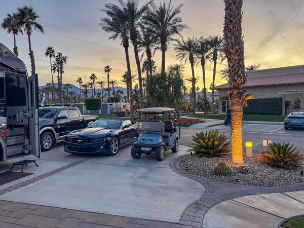 a view of a kitchen with kitchen island granite countertop a table chairs stove and a wooden floor