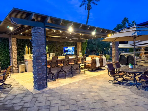 a view of a patio with dining table and chairs