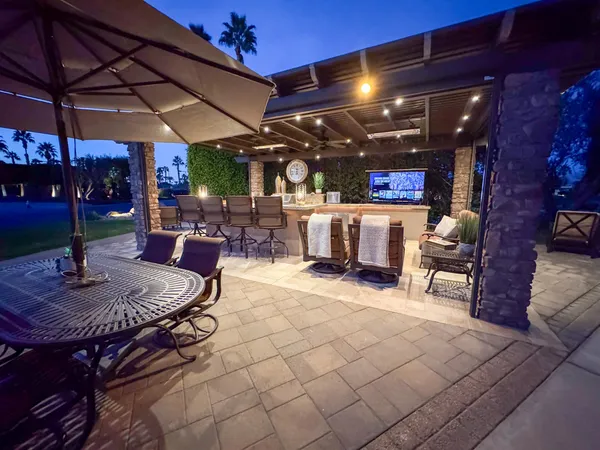a view of a patio with a table chairs and a fire pit