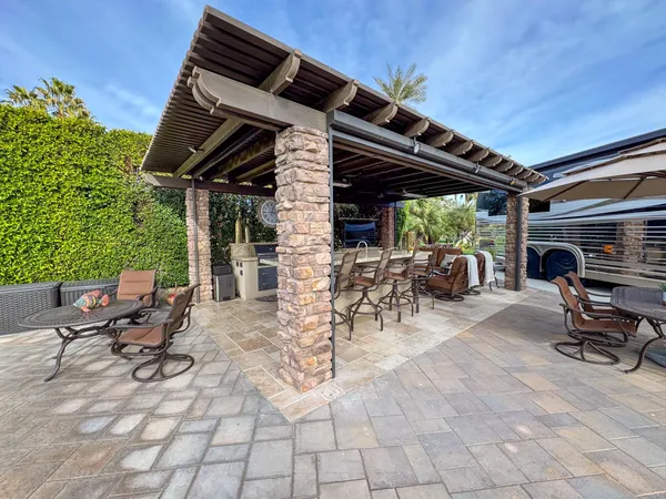 a view of a chairs and table in the patio
