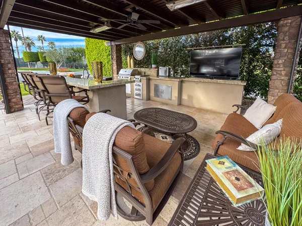 a view of a patio with a table chairs and a umbrella
