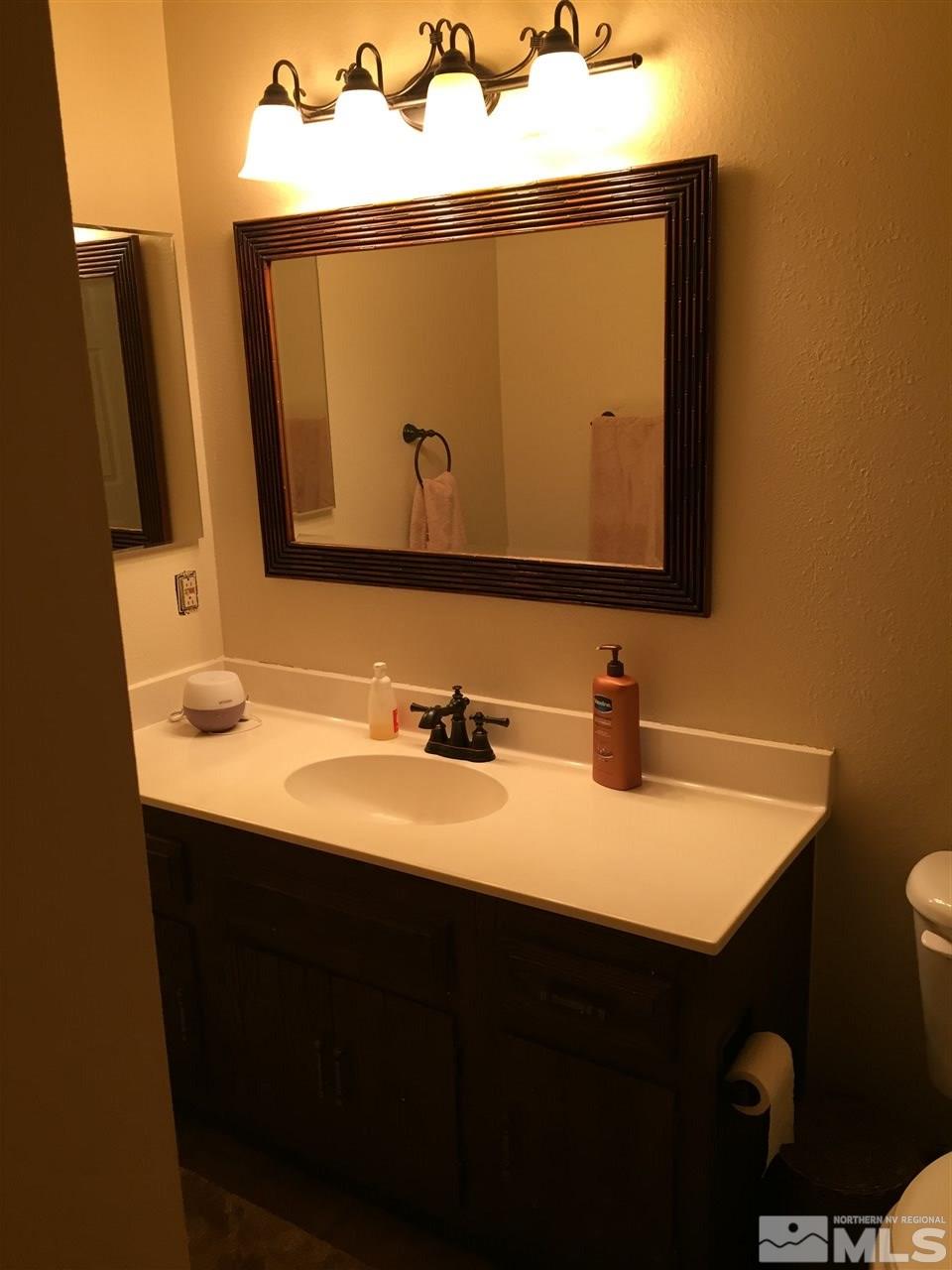 1800 Severn Drive Reno, NV 89503 - Photo 14 of 21 a bathroom with a sink vanity and a mirror