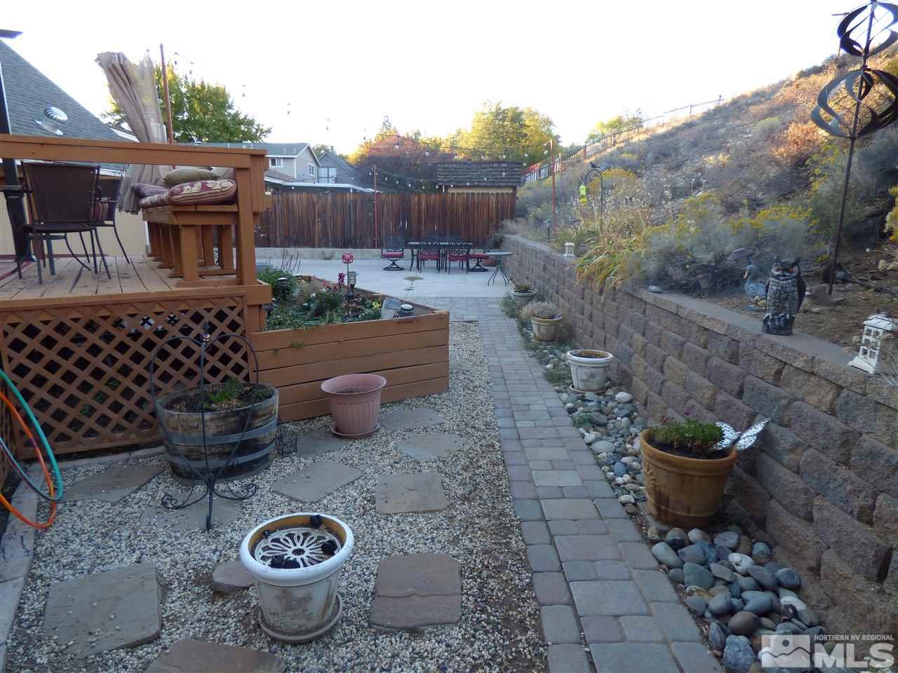1800 Severn Drive Reno, NV 89503 - Photo 19 of 21 a view of a backyard with table and chairs potted plants