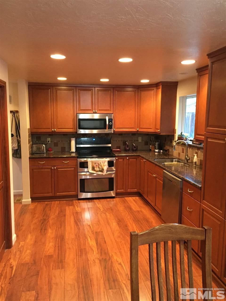 1800 Severn Drive Reno, NV 89503 - Photo 5 of 21 a kitchen with stainless steel appliances granite countertop a stove a sink dishwasher and a refrigerator
