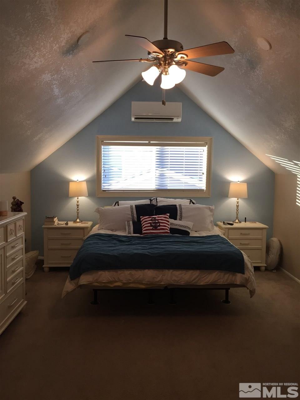1800 Severn Drive Reno, NV 89503 - Photo 10 of 21 a spacious bedroom with a bed and a chandelier