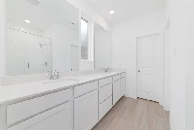 a bathroom with 2 sink and a mirror