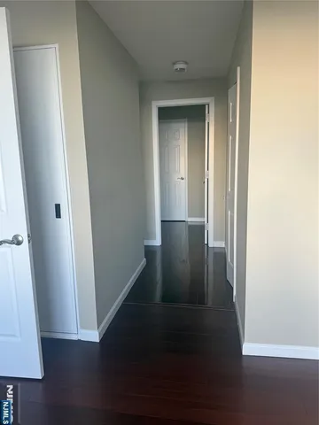 a view of hallway with wooden floor